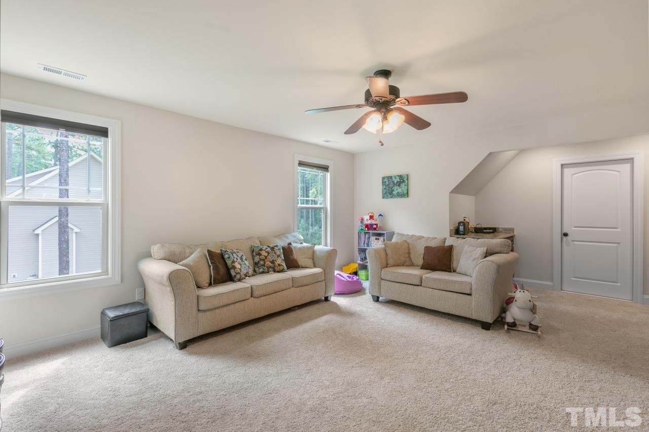 558 Fontana Drive Clayton, NC 27527 - Photo 22 of 41 a living room with furniture and a window