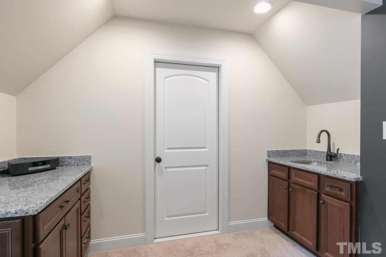 558 Fontana Drive Clayton, NC 27527 - Photo 24 of 41 a kitchen with a granite countertop sink and cabinets
