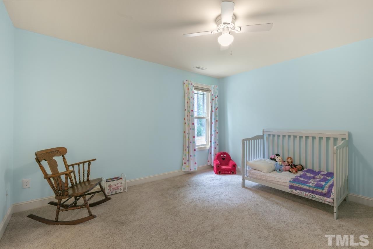 558 Fontana Drive Clayton, NC 27527 - Photo 29 of 41 a bedroom with furniture and a chandelier fan