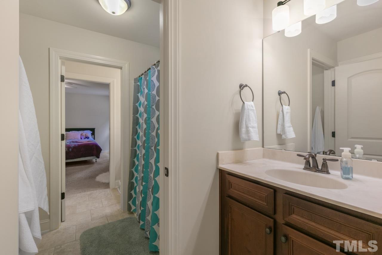 558 Fontana Drive Clayton, NC 27527 - Photo 31 of 41 a en suite bathroom with a sink and a mirror