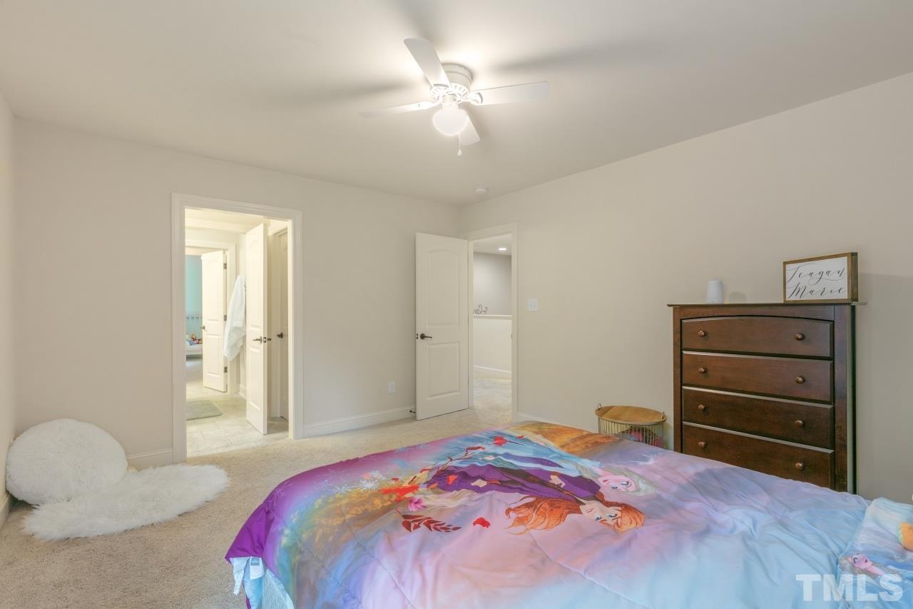 558 Fontana Drive Clayton, NC 27527 - Photo 33 of 41 a bedroom with a bed and a chandelier