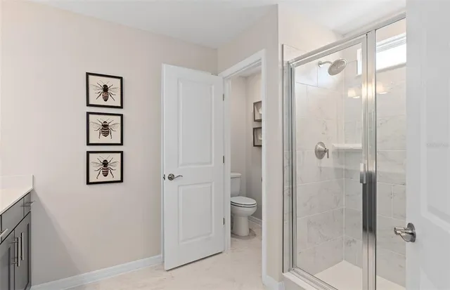 a bathroom with a shower and a glass door