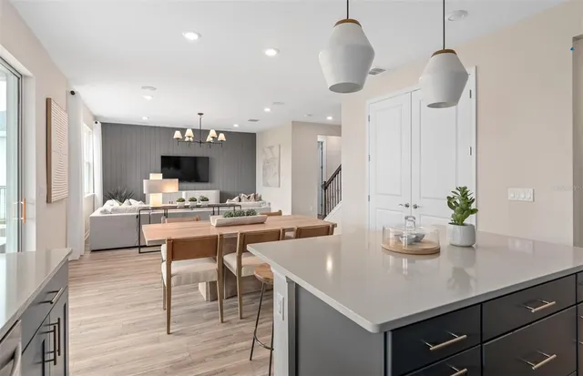 a kitchen with kitchen island stainless steel appliances a sink and white cabinets