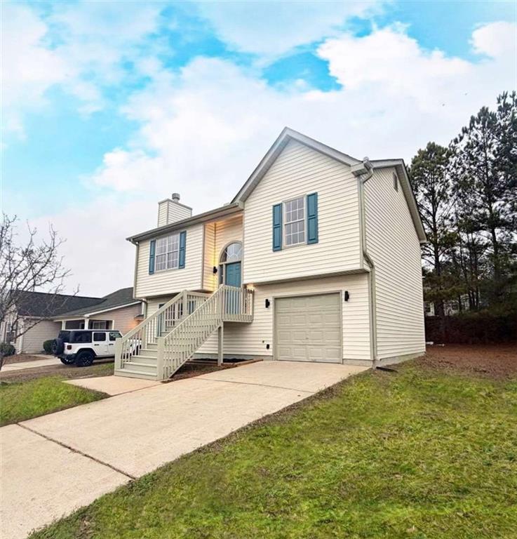 7027 Biscayne Rex, GA 30273 - Photo 1 of 1 a view of a white house with a yard and large trees