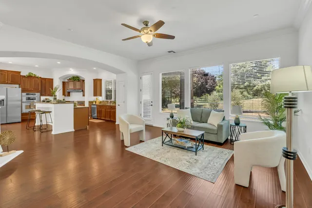 a view of a livingroom with wooden floor and furniture