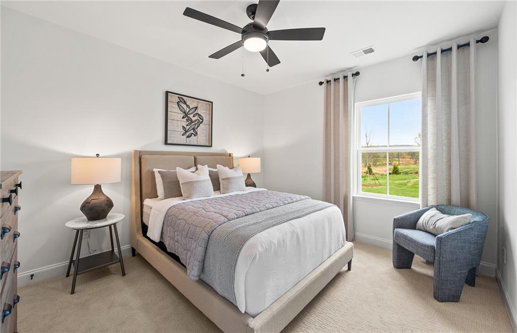 808 Tupelo Way Villa Rica, GA 30180 - Photo 26 of 48 a bedroom with a bed and a chandelier