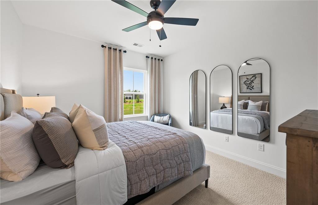 808 Tupelo Way Villa Rica, GA 30180 - Photo 27 of 48 a bedroom with bed and a chandelier