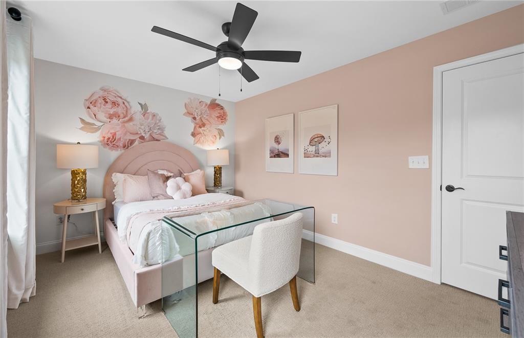 808 Tupelo Way Villa Rica, GA 30180 - Photo 41 of 48 a bedroom with a bed and a chandelier