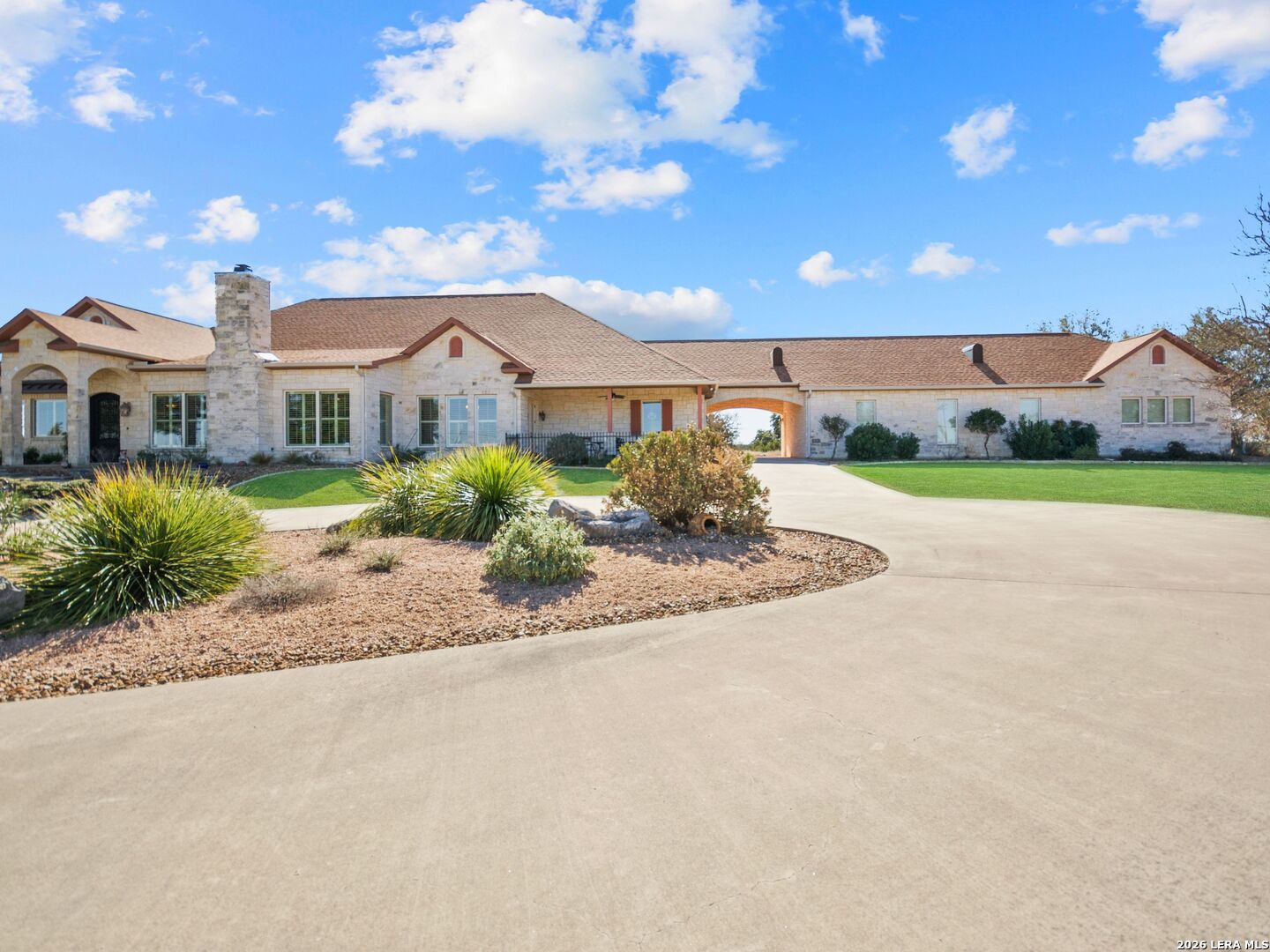 a view of a house with a big yard and large tree