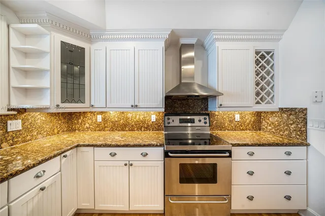 a kitchen with granite countertop a sink and cabinets