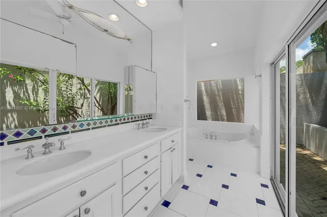 a bathroom with a sink mirror and a shower