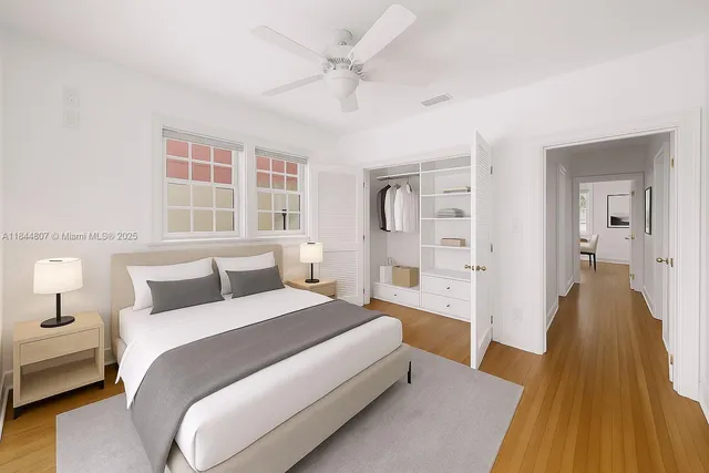 a view of a livingroom with wooden floor and a ceiling fan
