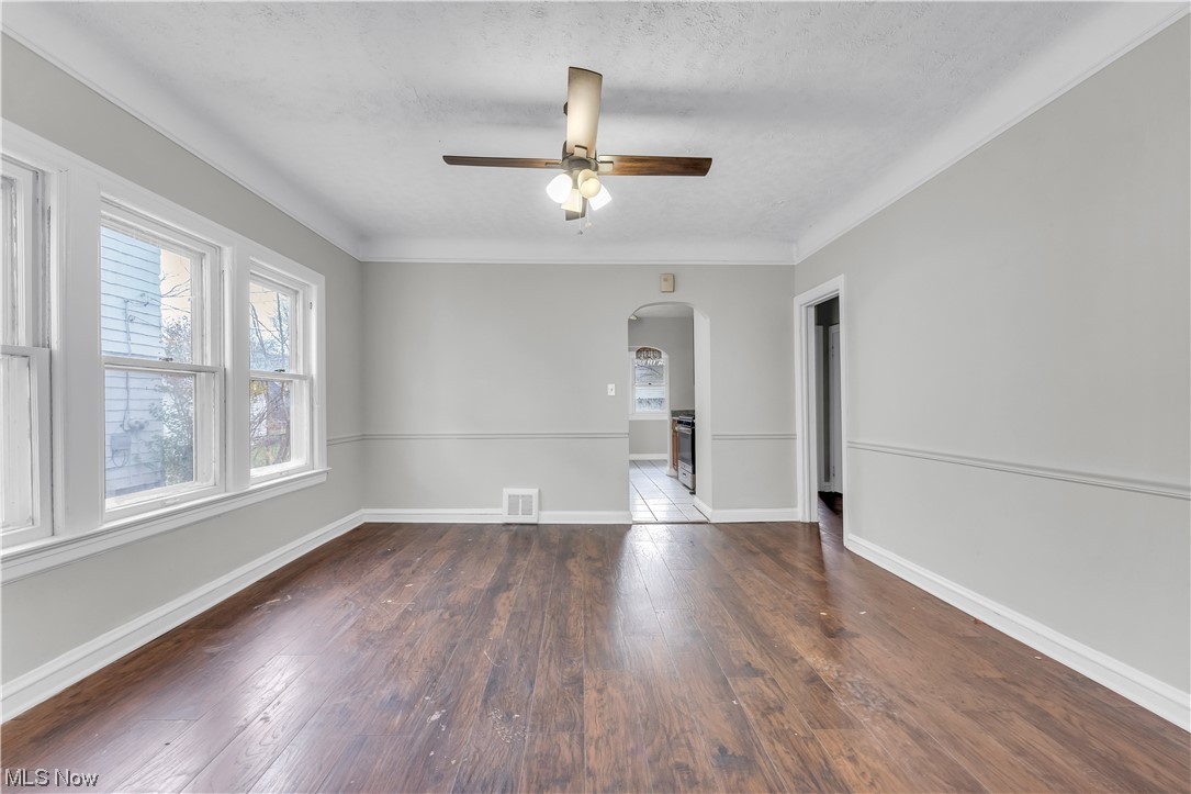 1499 Sherbrook Road South Euclid, OH 44121 - Photo 29 of 41 Unfurnished room with ornamental molding, ceiling fan, a textured ceiling, and wood-type flooring