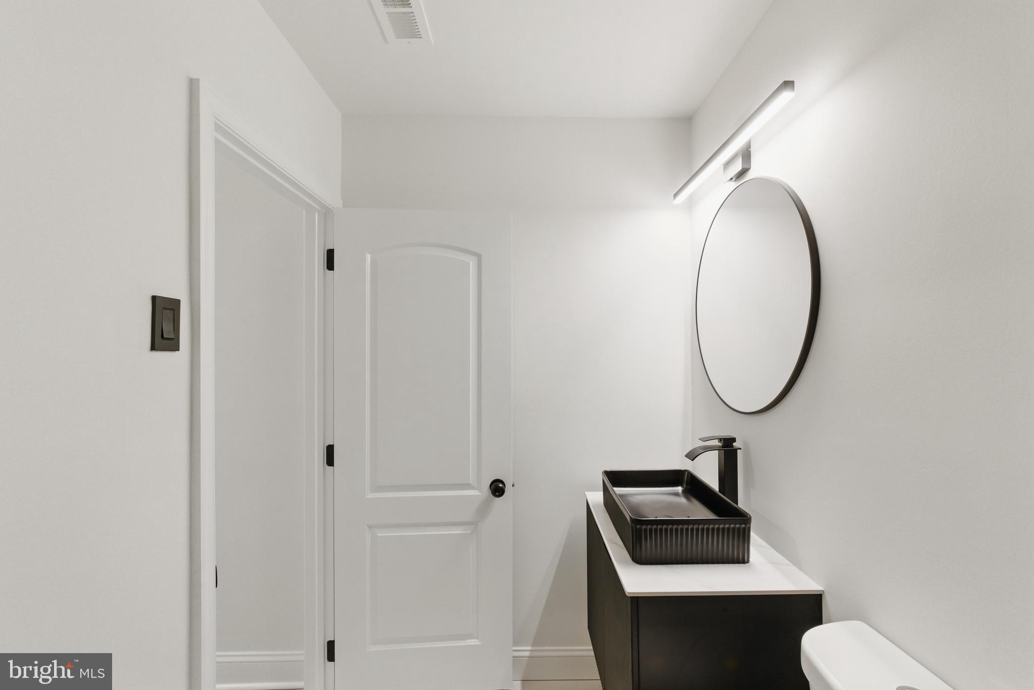 1208 June Road Huntingdon Valley, PA 19006 - Photo 20 of 36 a bathroom with a toilet a sink and mirror
