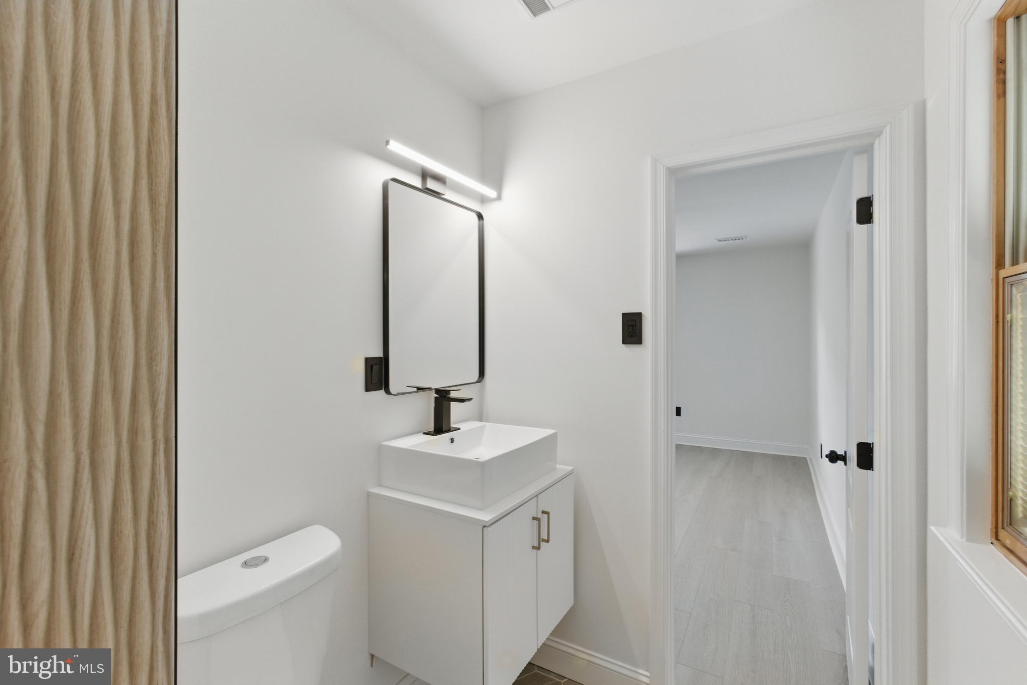 1208 June Road Huntingdon Valley, PA 19006 - Photo 25 of 36 a bathroom with a sink a toilet and a mirror