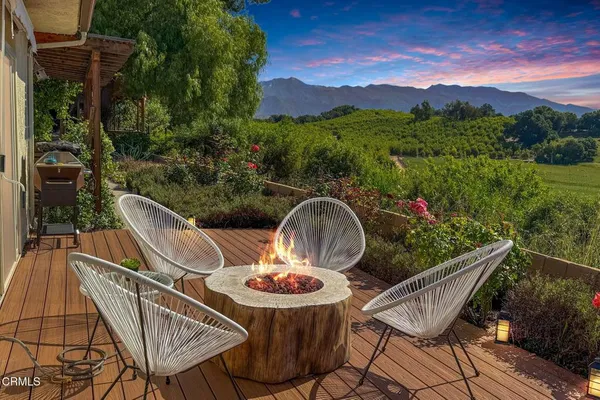 a view of a chairs and table in patio