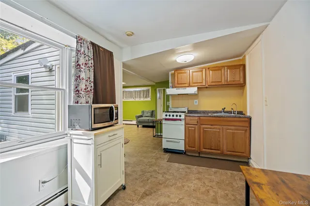 a kitchen with a stove a sink and a refrigerator