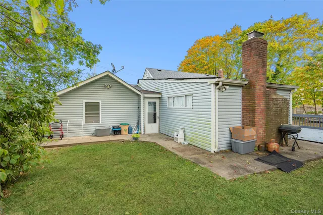 a backyard of a house with table and chairs