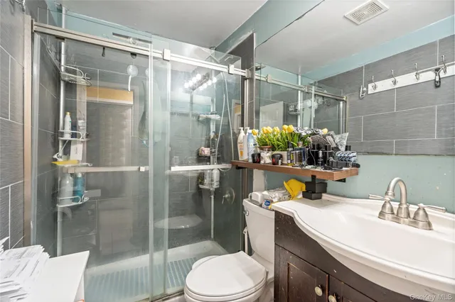 a bathroom with a sink toilet and shower