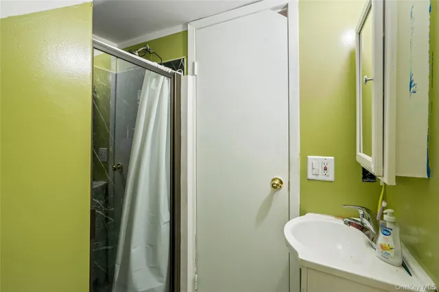 a bathroom with a sink a mirror and shower