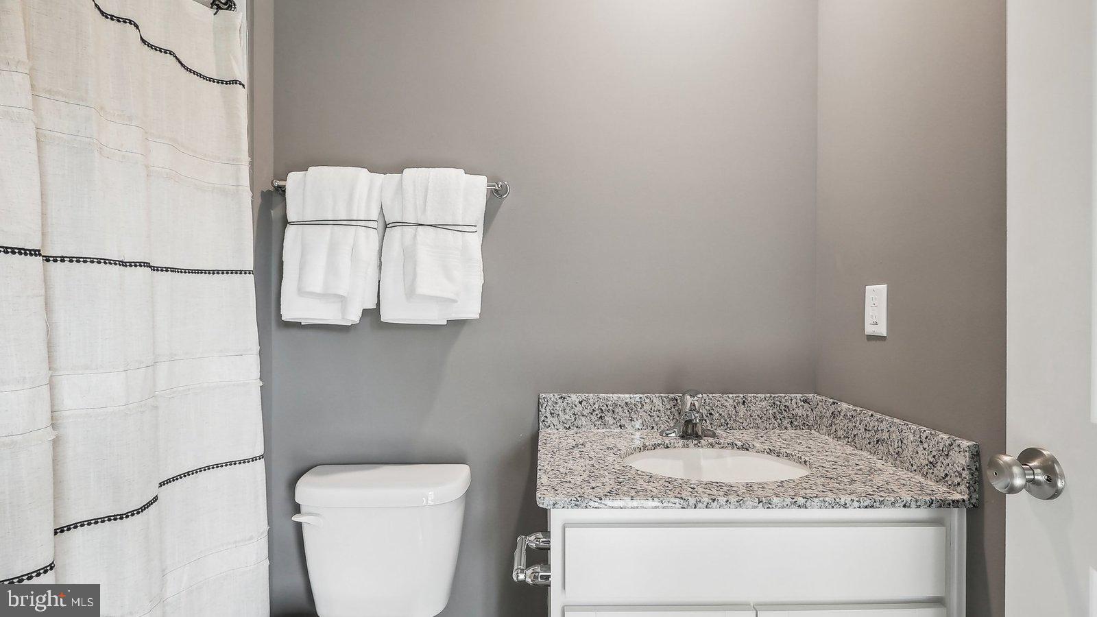 190 Sioux Loop Winchester, VA 22602 - Photo 22 of 44 a bathroom with a granite countertop sink and a mirror