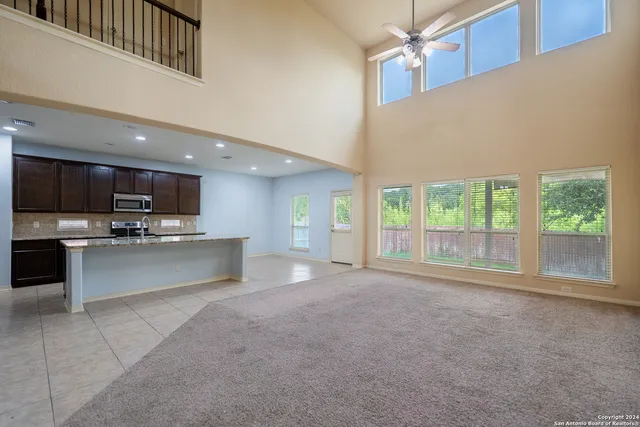 a large kitchen with stainless steel appliances kitchen island a large counter top and oven