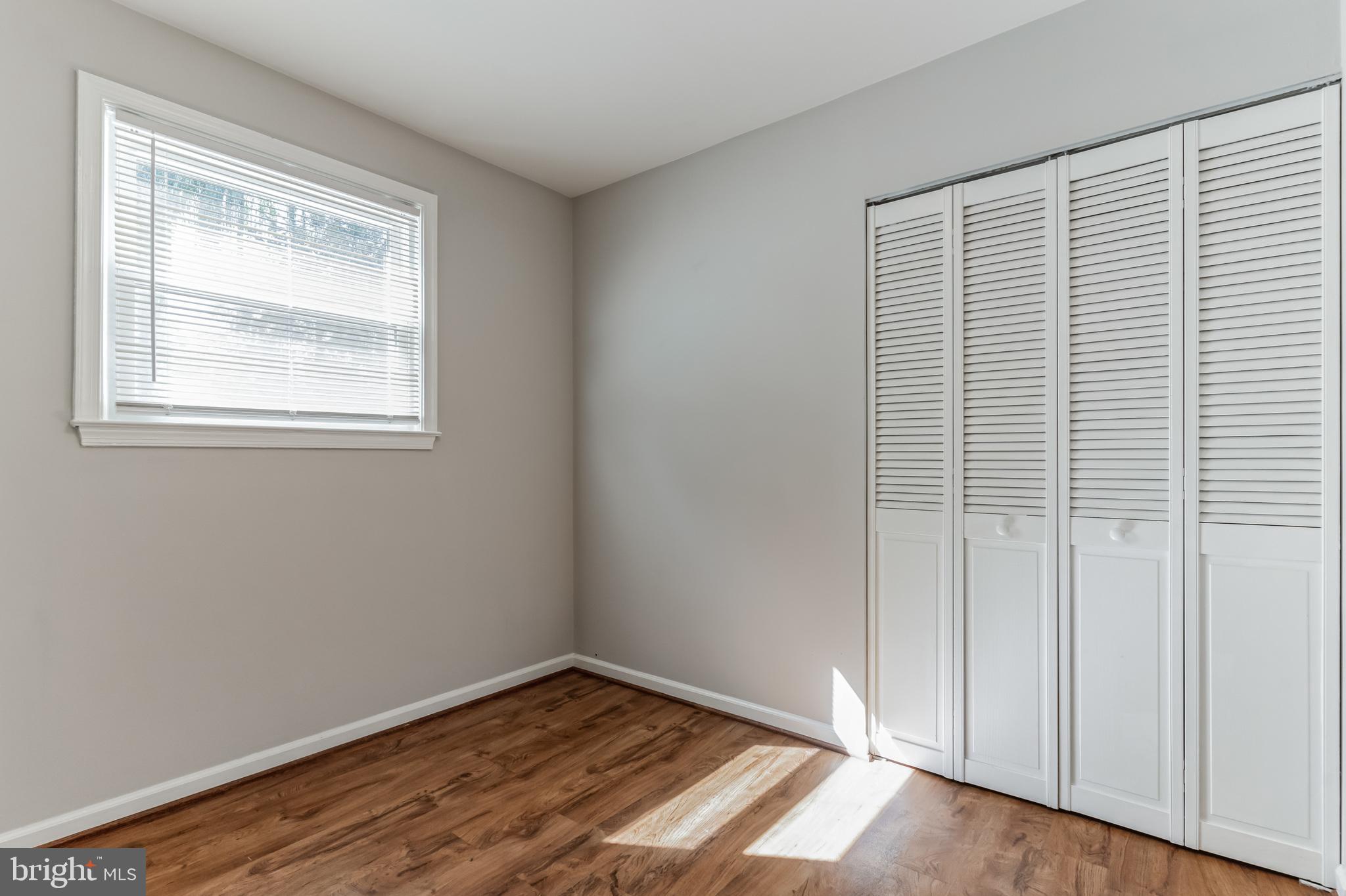 6414 Winnepeg Road Bethesda, MD 20817 - Photo 11 of 20 a view of an empty room with wooden floor and a window