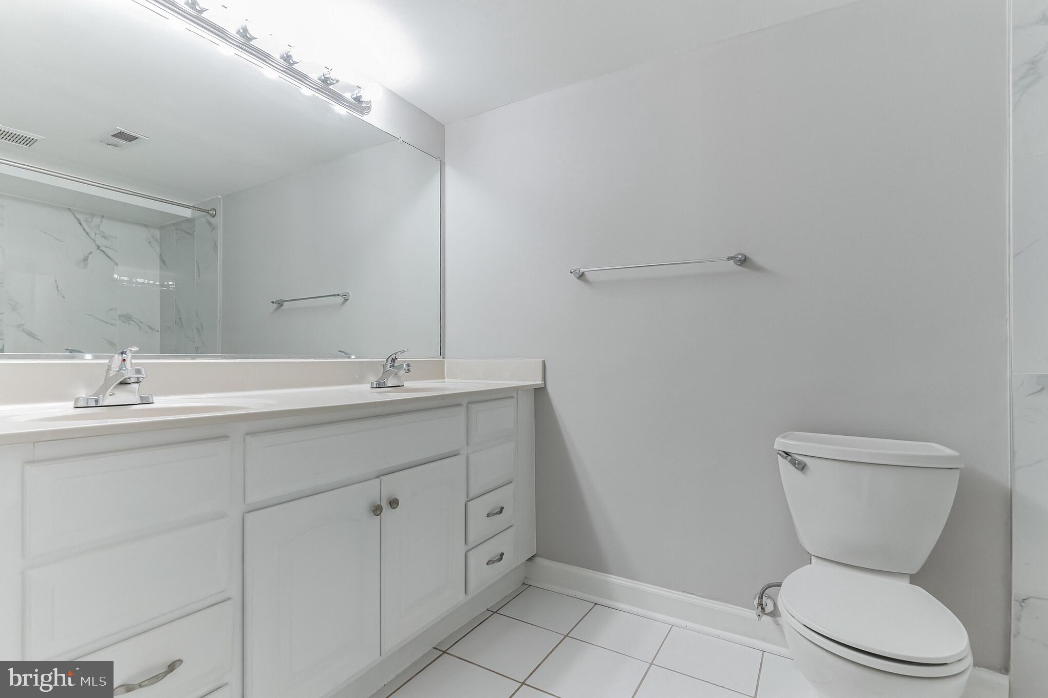 6414 Winnepeg Road Bethesda, MD 20817 - Photo 12 of 20 a bathroom with a toilet sink and mirror