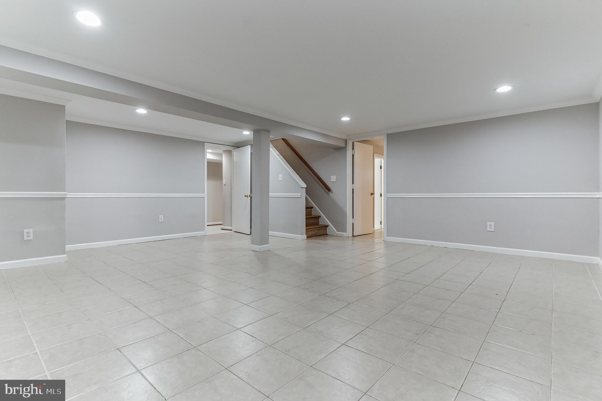 6414 Winnepeg Road Bethesda, MD 20817 - Photo 14 of 20 an empty room with white walls and stairs