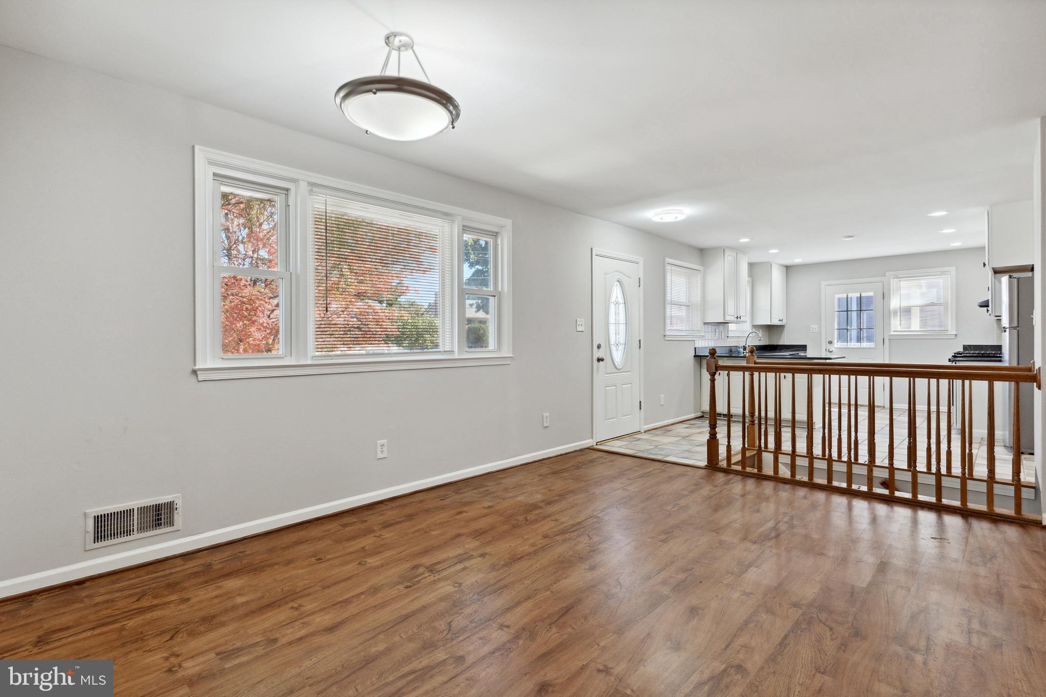 6414 Winnepeg Road Bethesda, MD 20817 - Photo 3 of 20 a view of an empty room with wooden floor and a window