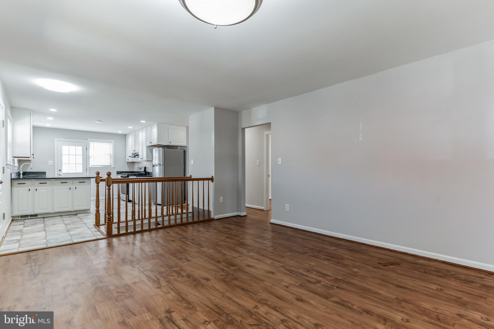 6414 Winnepeg Road Bethesda, MD 20817 - Photo 5 of 20 a view of a kitchen with wooden floor and stairs