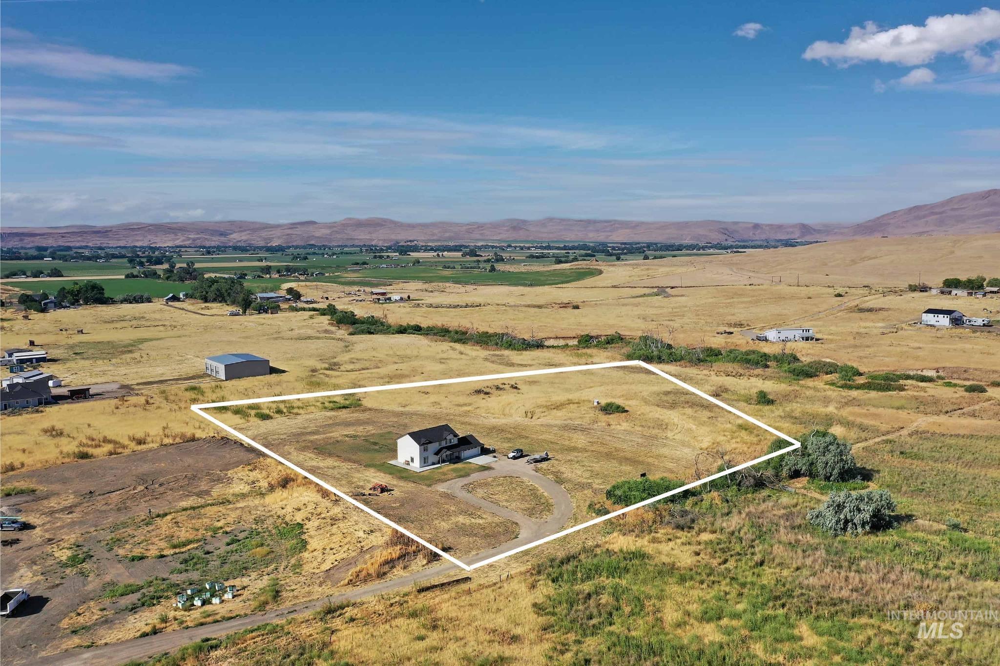 1049 Price Road Weiser, ID 83672 - Photo 39 of 47 Expansive rural property featuring a two-story residence with a dark roof and light-colored siding