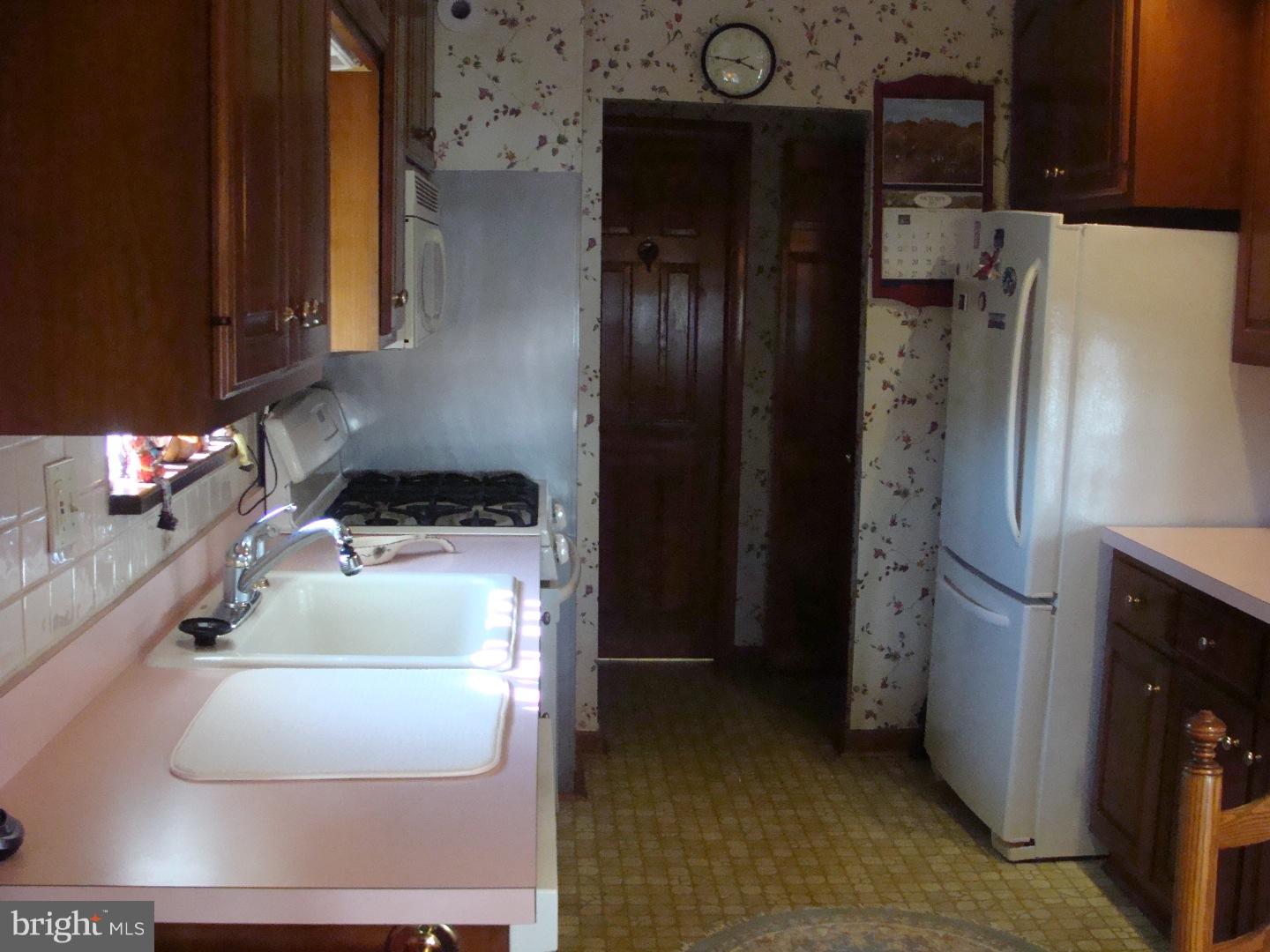 13037 Worthington Road Philadelphia, PA 19116 - Photo 4 of 15 a kitchen with a refrigerator and a stove