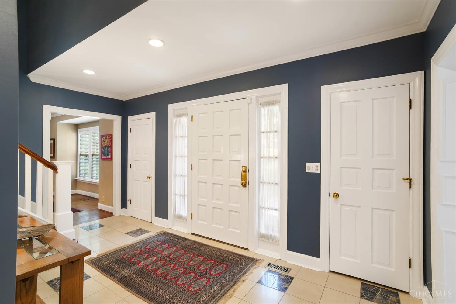 2780 Walsh Road Cincinnati, OH 45208 - Photo 2 of 68 A gracious, well-proportioned entry welcomes you with timeless appeal—featuring crisp white millwork, this light-filled foyer that sets the tone for the home’s elegant interior. The central staircase serves as a striking architectural focal point, while the thoughtful layout offers seamless flow to surrounding living spaces.