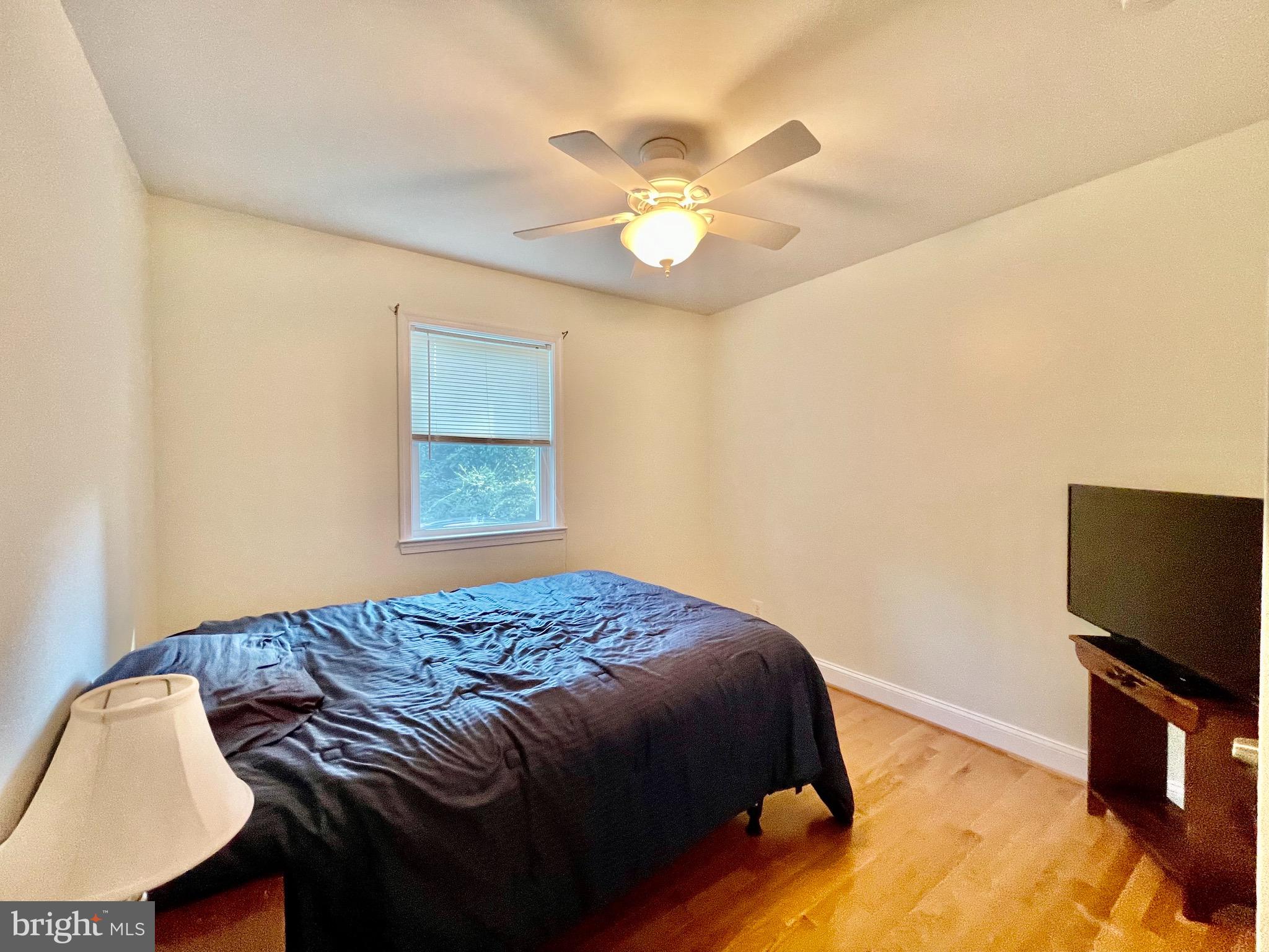 1270 Calvert Beach Road St. Leonard, MD 20685 - Photo 17 of 31 a bedroom with a bed and a flat screen tv
