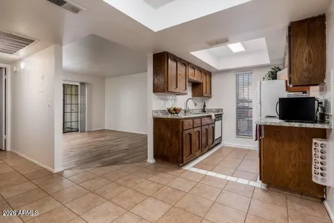 a kitchen with stainless steel appliances kitchen island granite countertop a refrigerator and a stove top oven