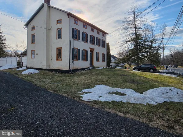 a view of a white house with a yard