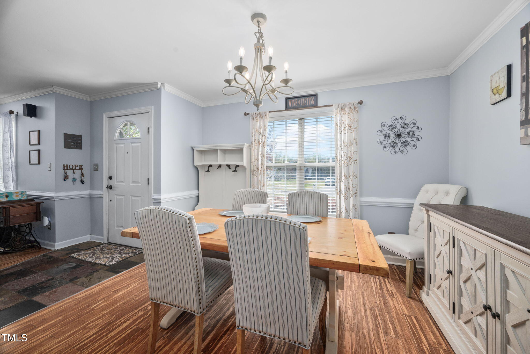 Undisclosed Address Garner, NC 27529 - Photo 10 of 35 a view of a dining room with furniture a chandelier and wooden floor