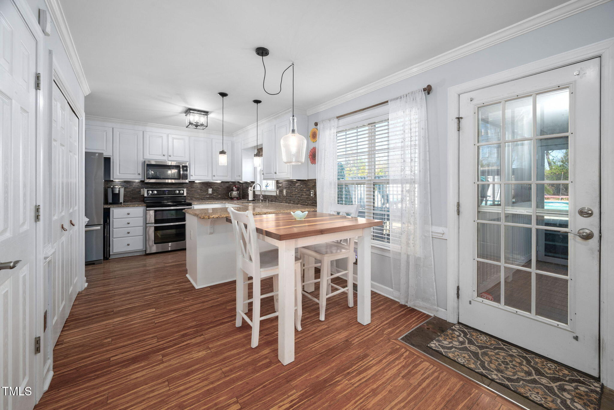 Undisclosed Address Garner, NC 27529 - Photo 11 of 35 a view of a dining room with furniture window and wooden floor