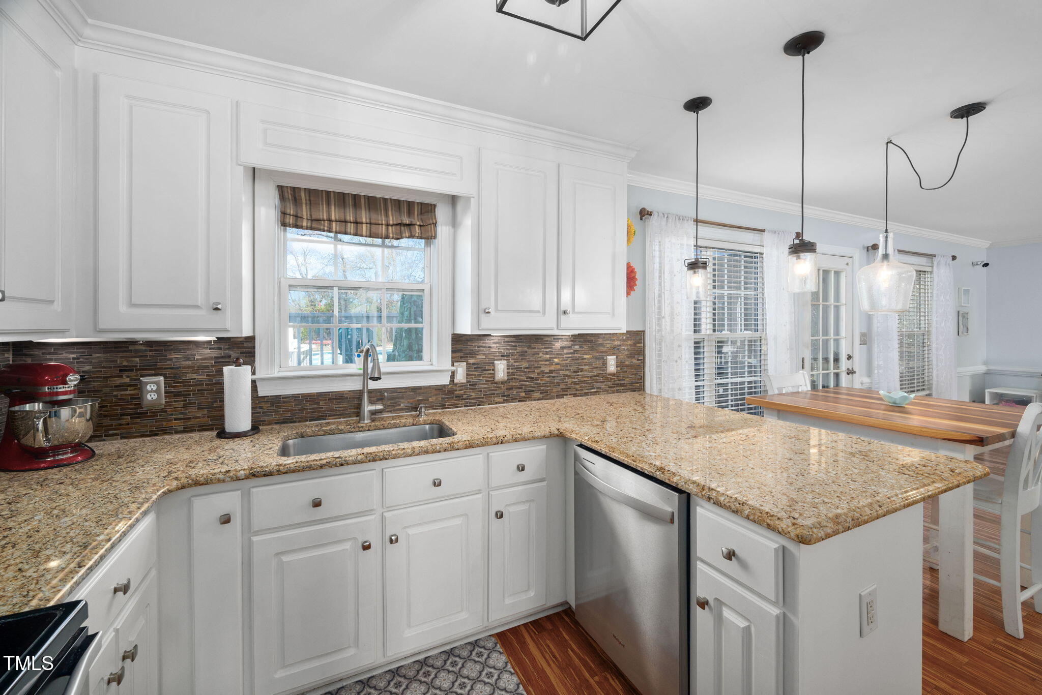 Undisclosed Address Garner, NC 27529 - Photo 12 of 35 a kitchen with a sink dishwasher a stove a washer and dryer with wooden floor