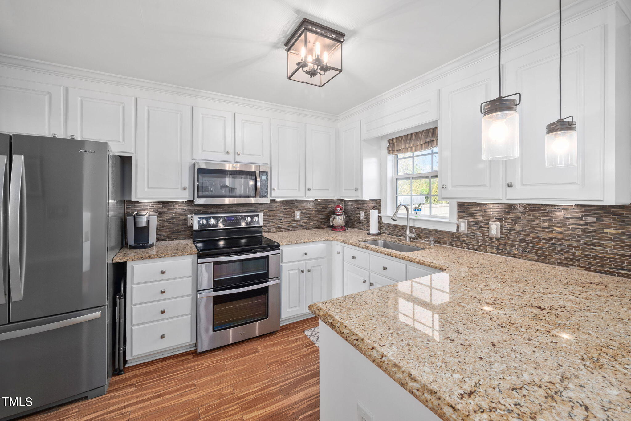 Undisclosed Address Garner, NC 27529 - Photo 13 of 35 a kitchen with granite countertop a refrigerator stove and sink