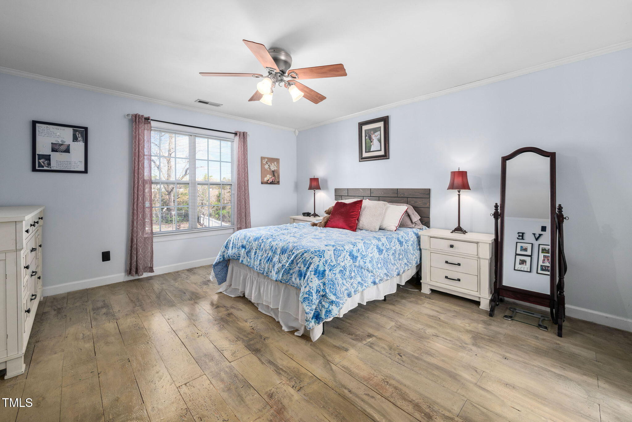 Undisclosed Address Garner, NC 27529 - Photo 16 of 35 a bedroom with a large bed and a chandelier