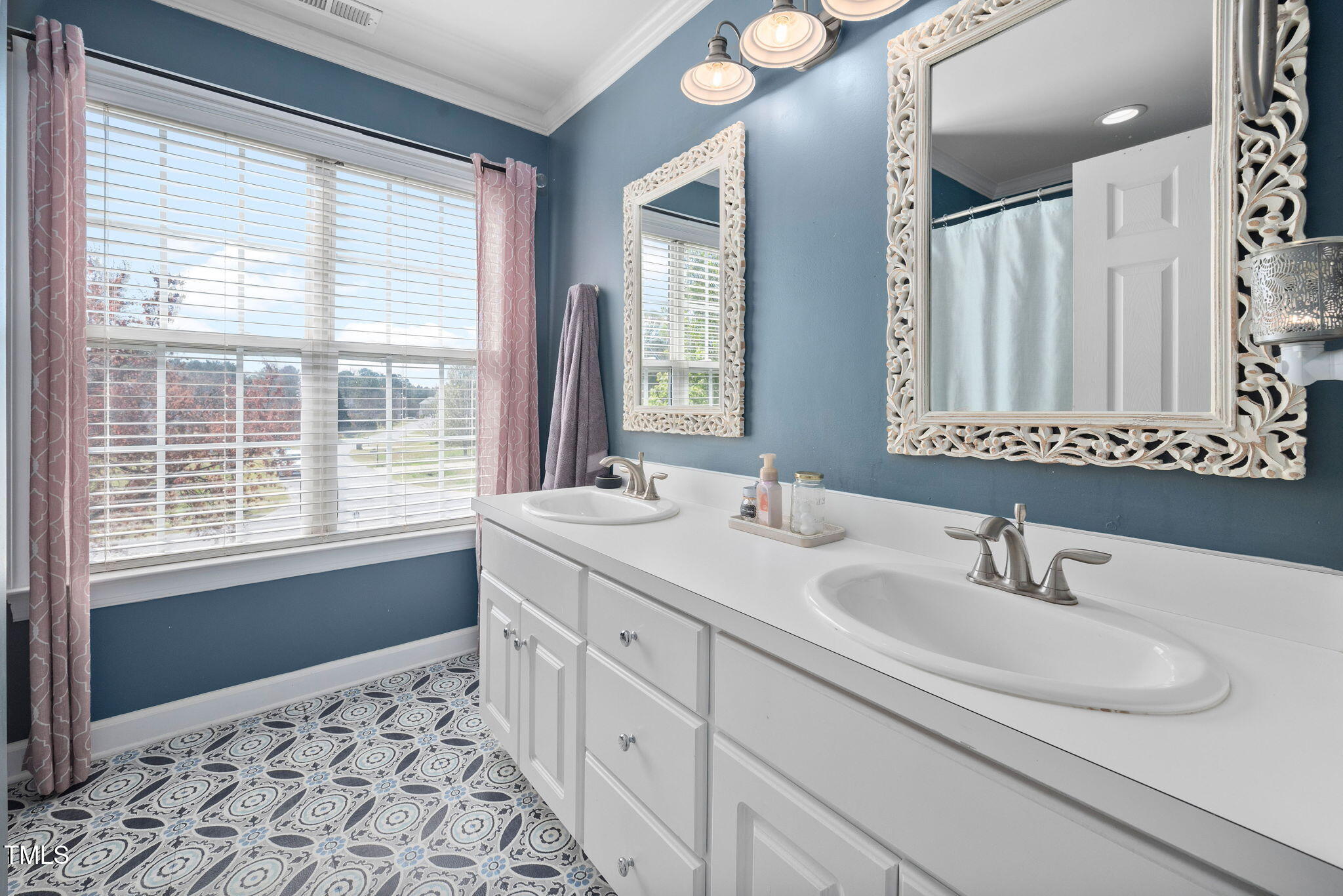Undisclosed Address Garner, NC 27529 - Photo 18 of 35 a bathroom with double vanity and a mirror