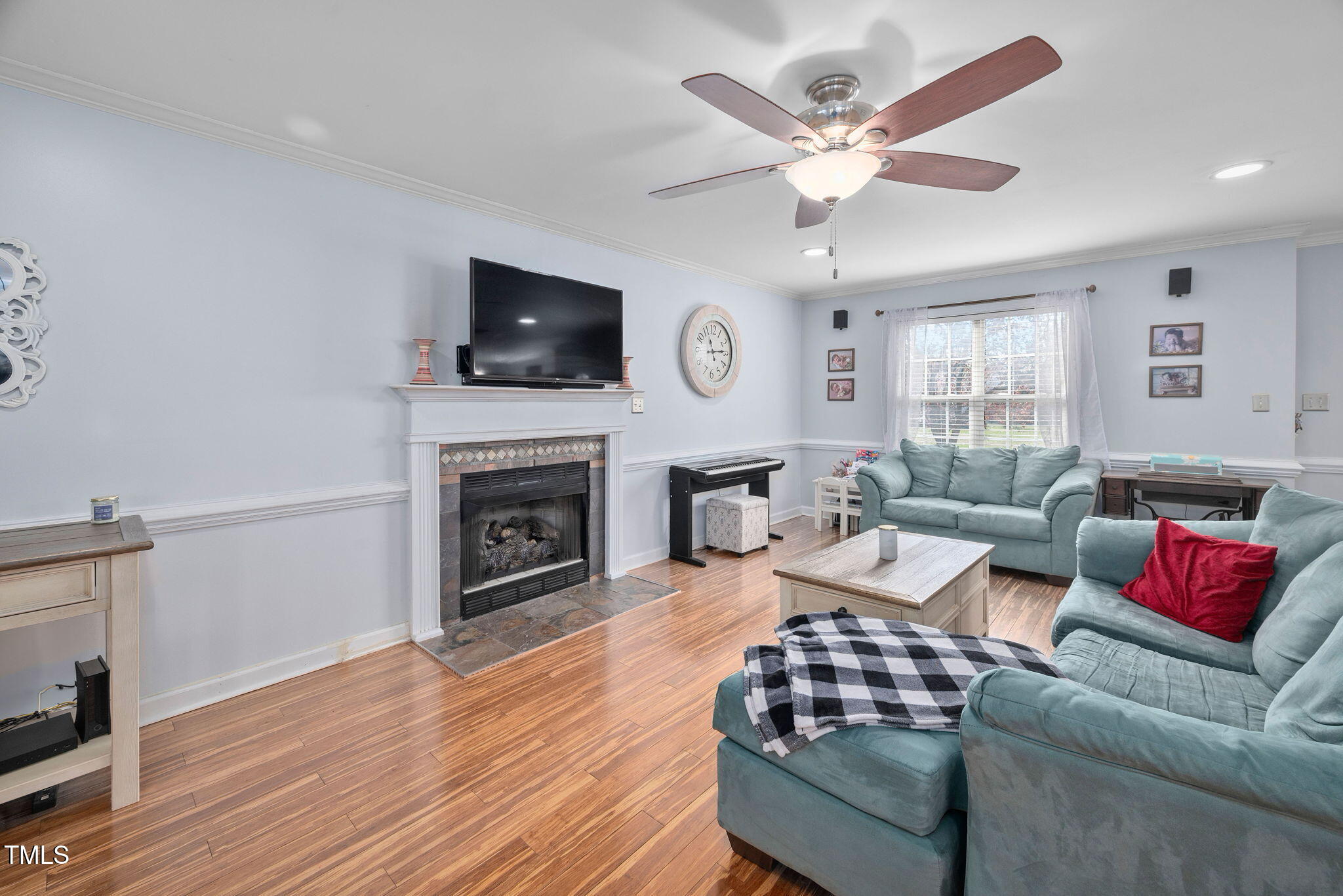 Undisclosed Address Garner, NC 27529 - Photo 6 of 35 a living room with furniture a fireplace and a flat screen tv