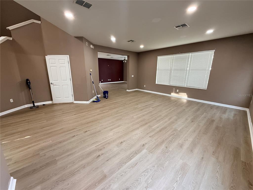 4199 Southwest 46th Court Ocala, FL 34474 - Photo 11 of 50 an empty room with wooden floor and windows