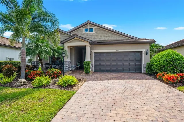 a front view of a house with a yard and potted plants