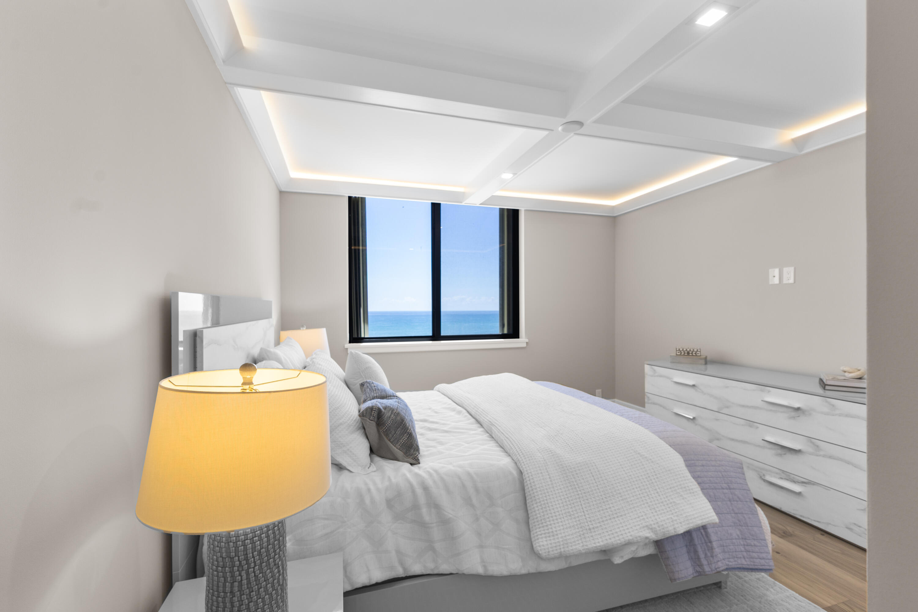 400 Ocean Trail Way, Unit 1008 Jupiter, FL 33477 - Photo 16 of 25 a bedroom with a bed and dresser with mirror