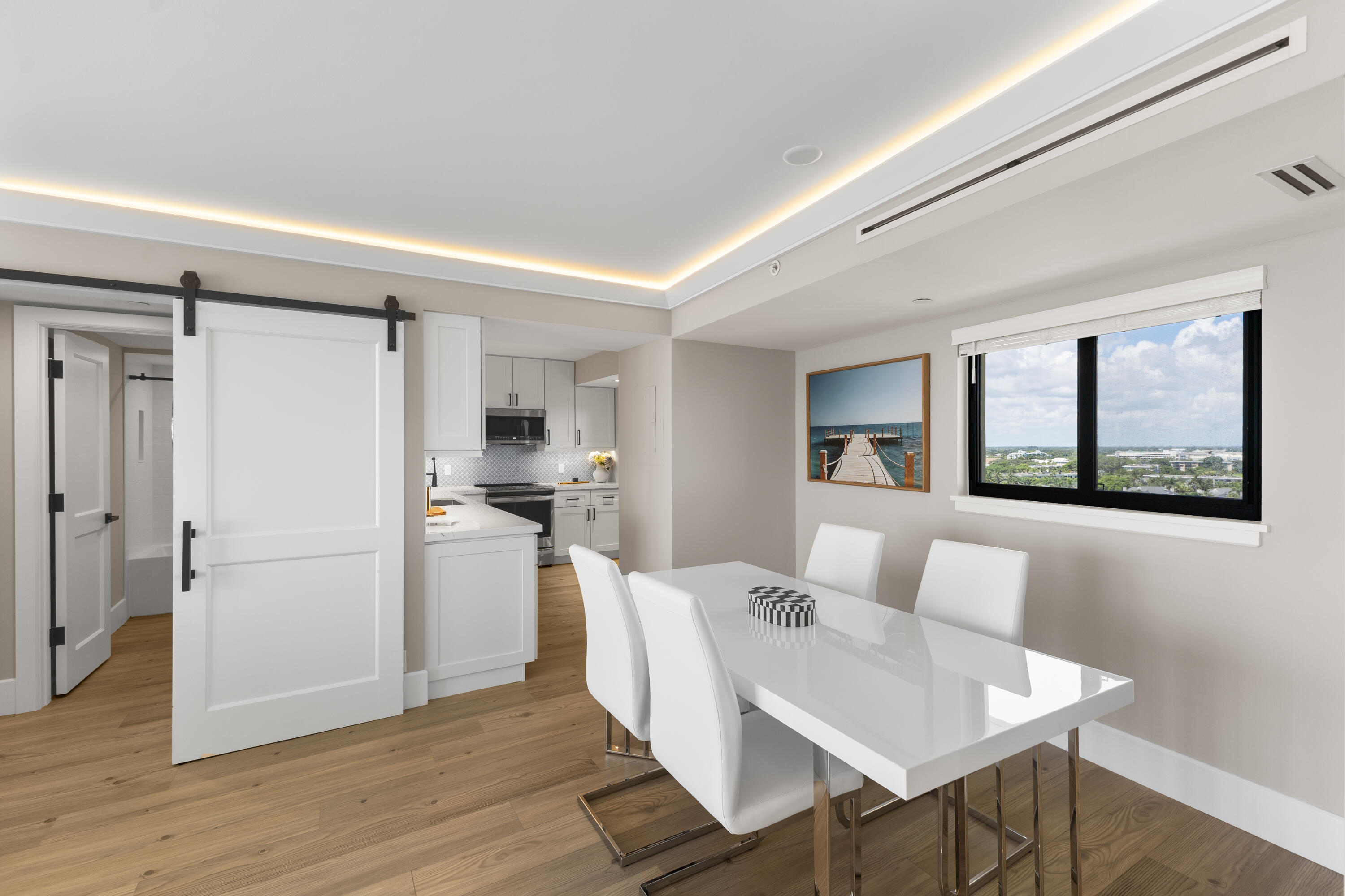 400 Ocean Trail Way, Unit 1008 Jupiter, FL 33477 - Photo 5 of 25 a kitchen with a table and chairs