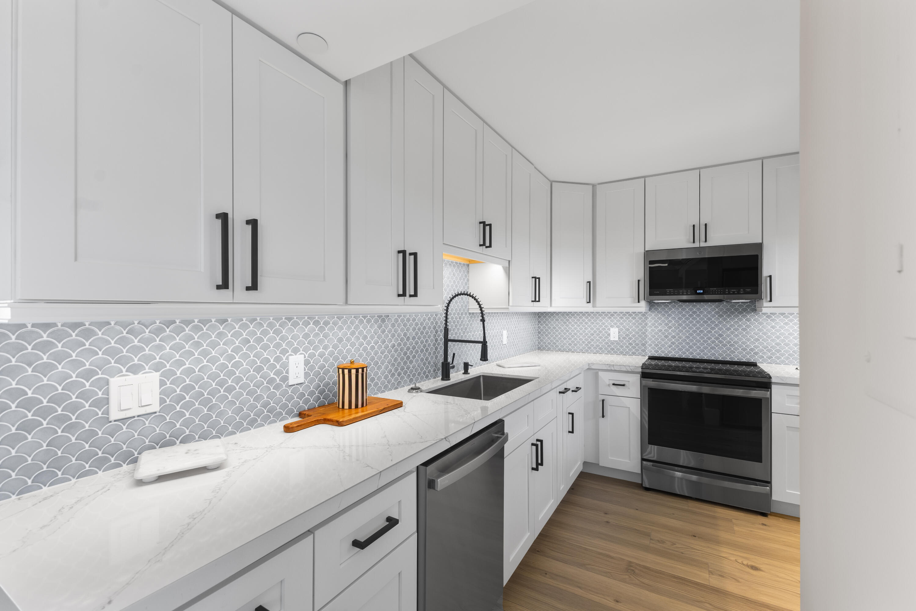 400 Ocean Trail Way, Unit 1008 Jupiter, FL 33477 - Photo 7 of 25 a kitchen with a sink white cabinets and stainless steel appliances