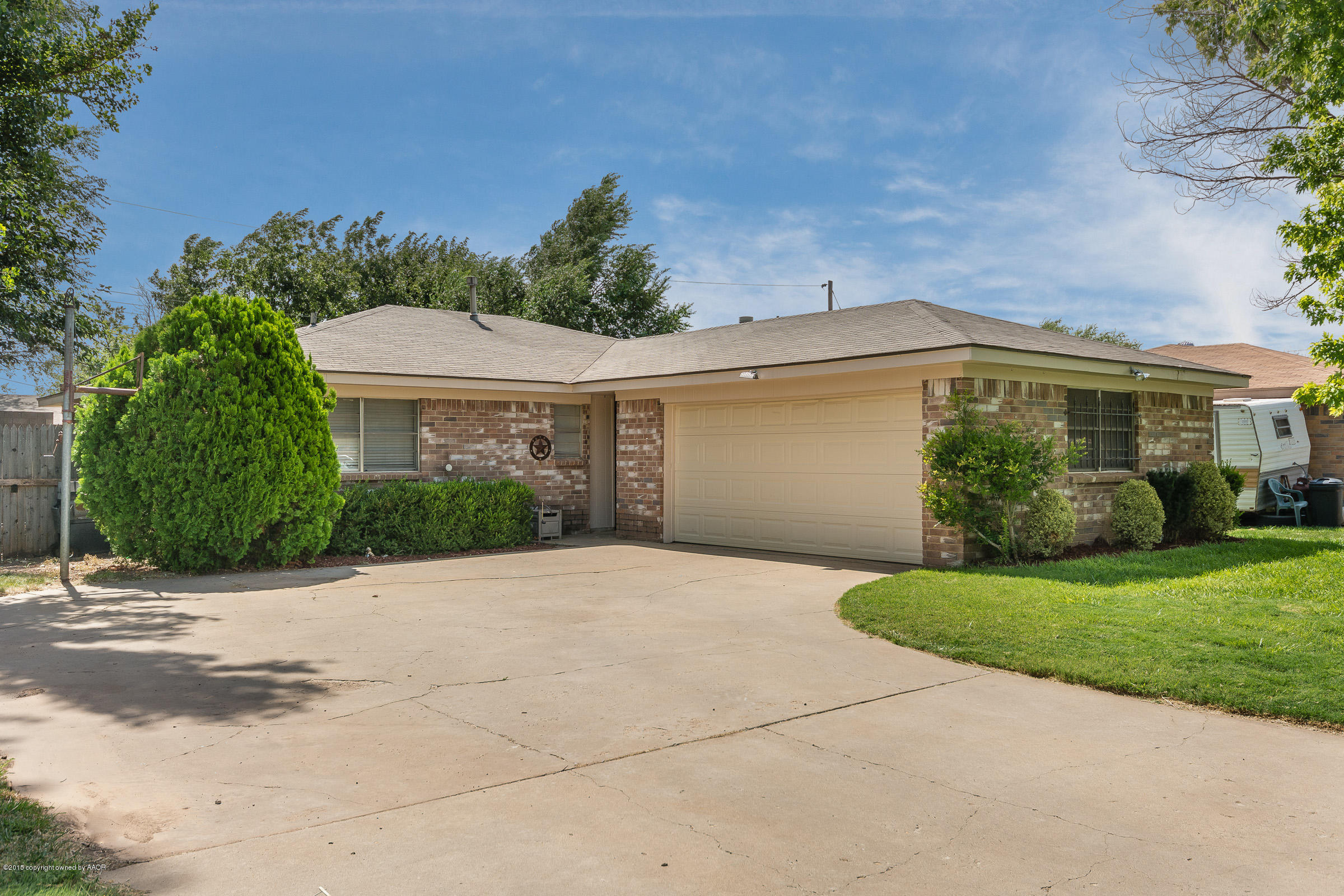 5017 Tulip Avenue Amarillo, TX 79110 - Photo 1 of 16 a view of a white house next to a yard with potted plants